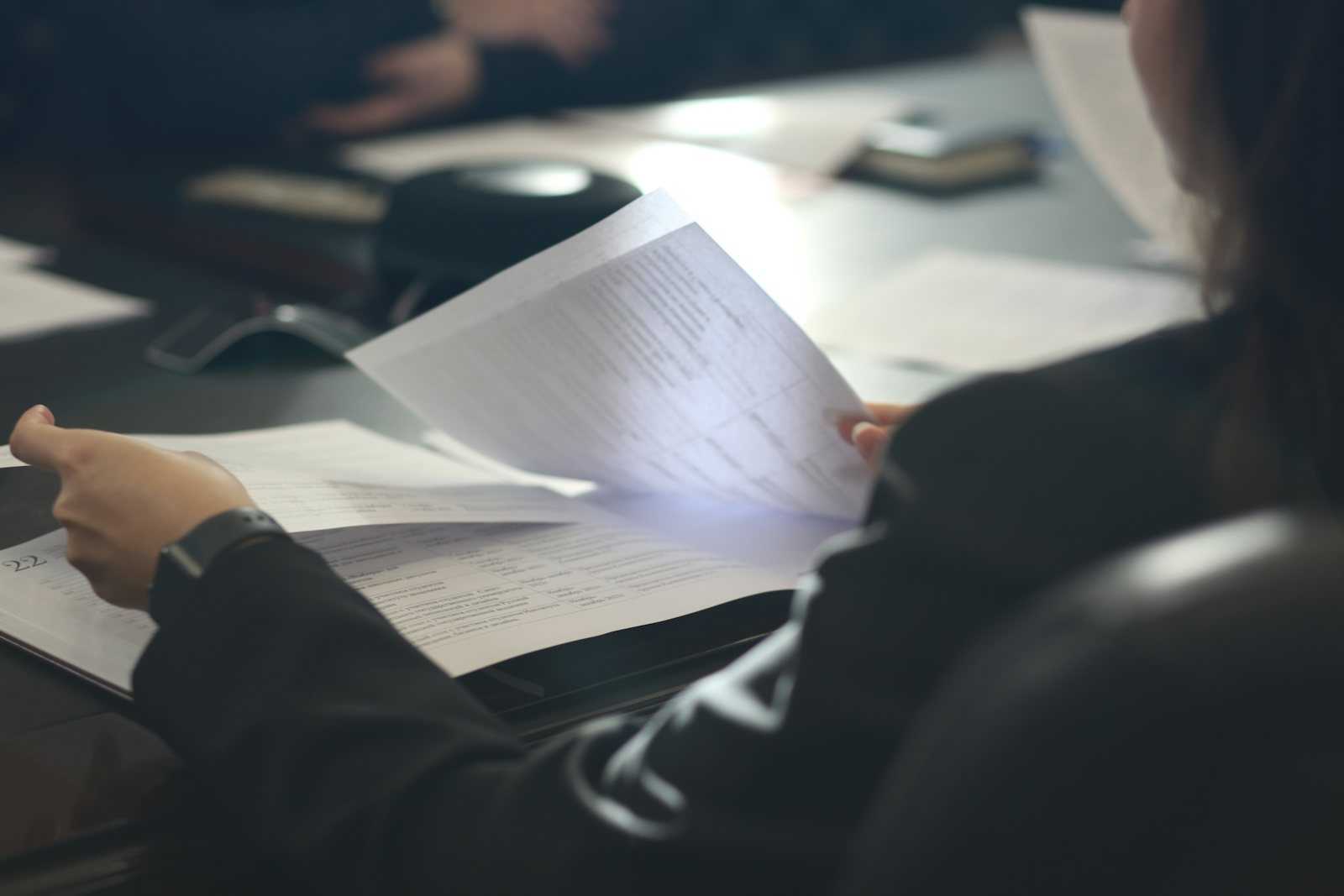 Woman reviewing paperwork at a table
