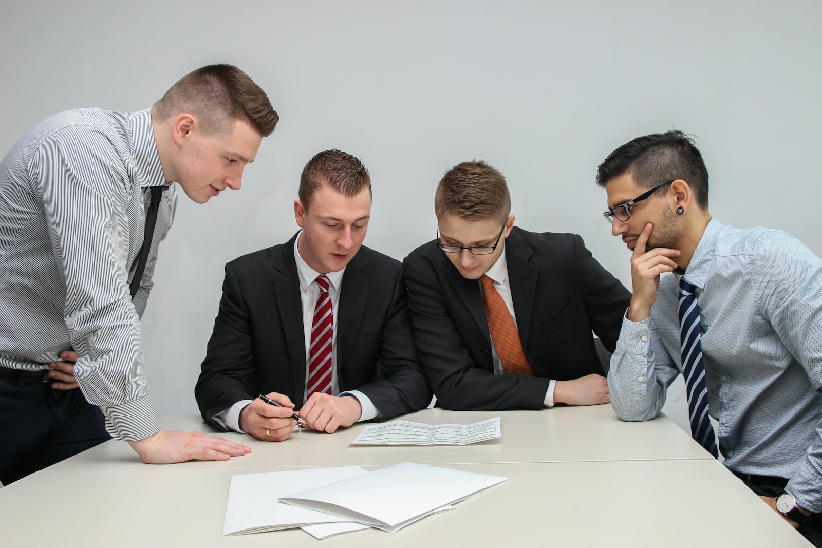 Advisers reviewing documents together at a table