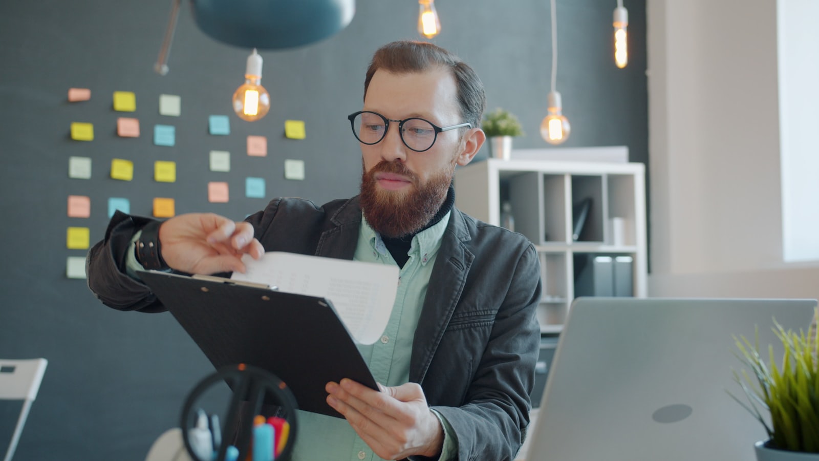 Adviser in glasses reviewing documents at a desk