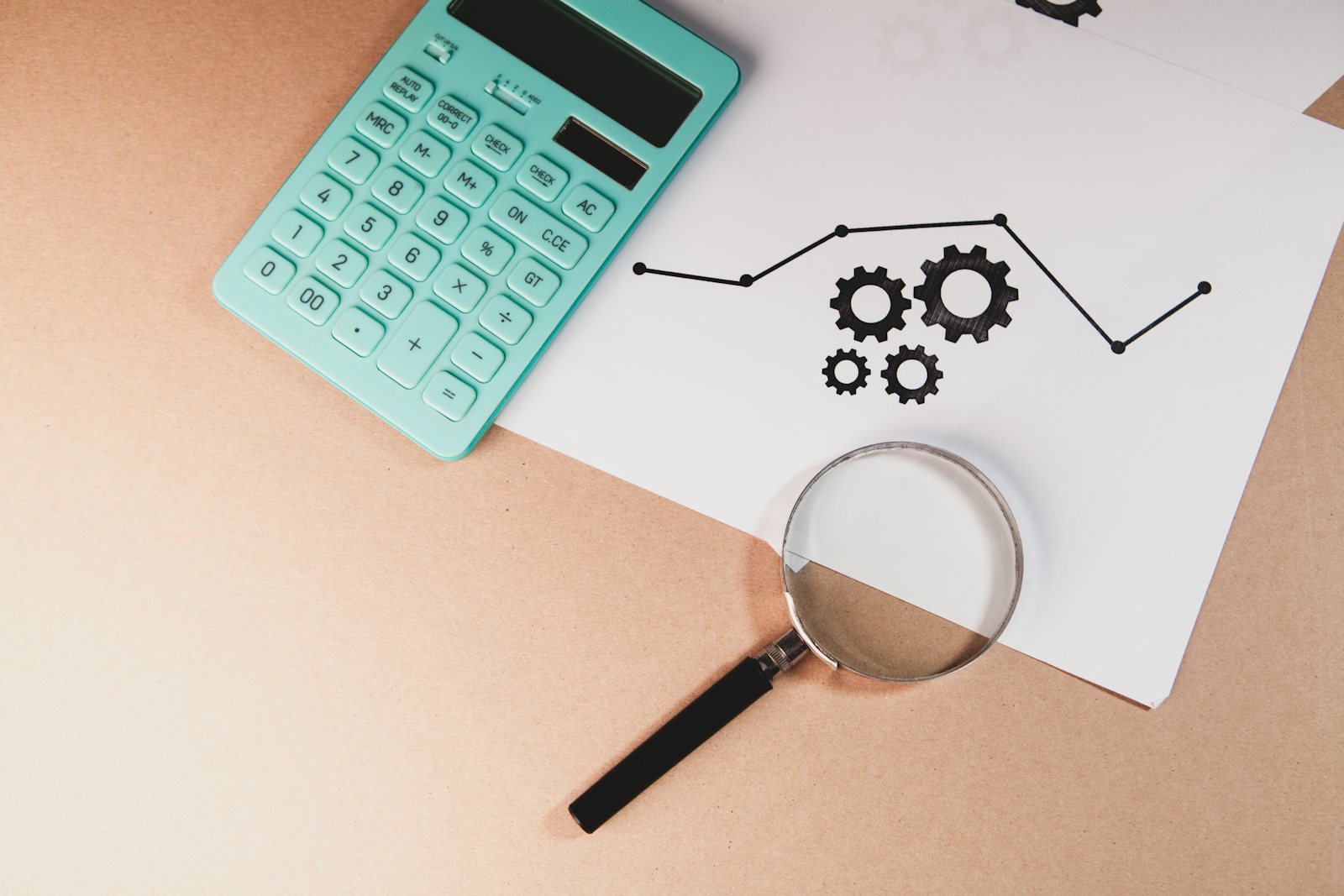 Calculator, magnifying glass and charts on a desk