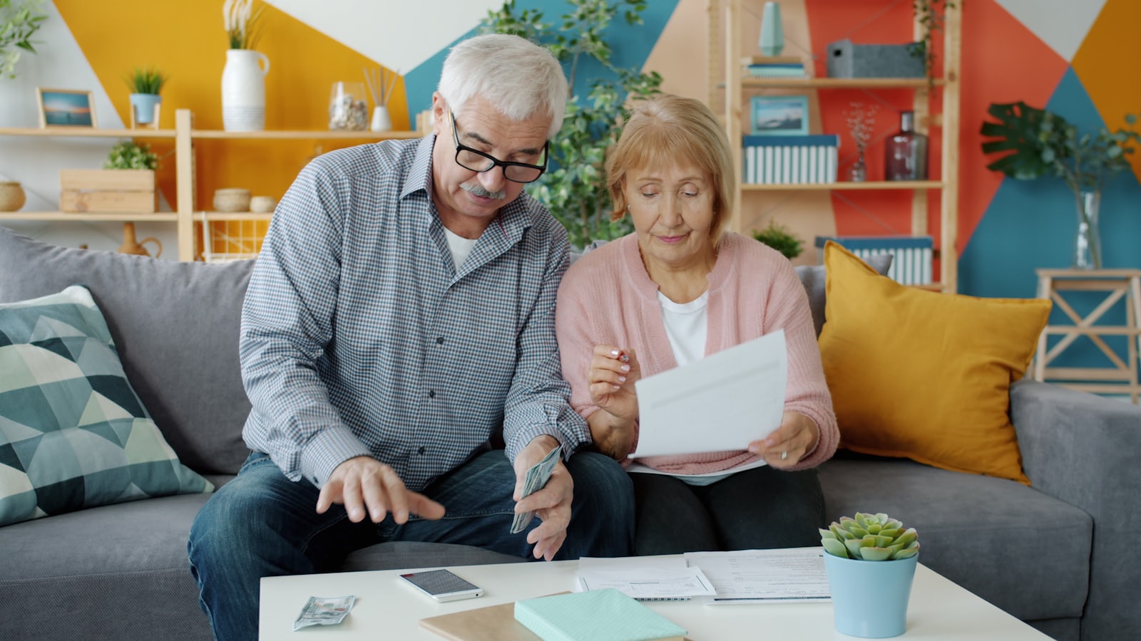 Couple reviewing financial documents at home