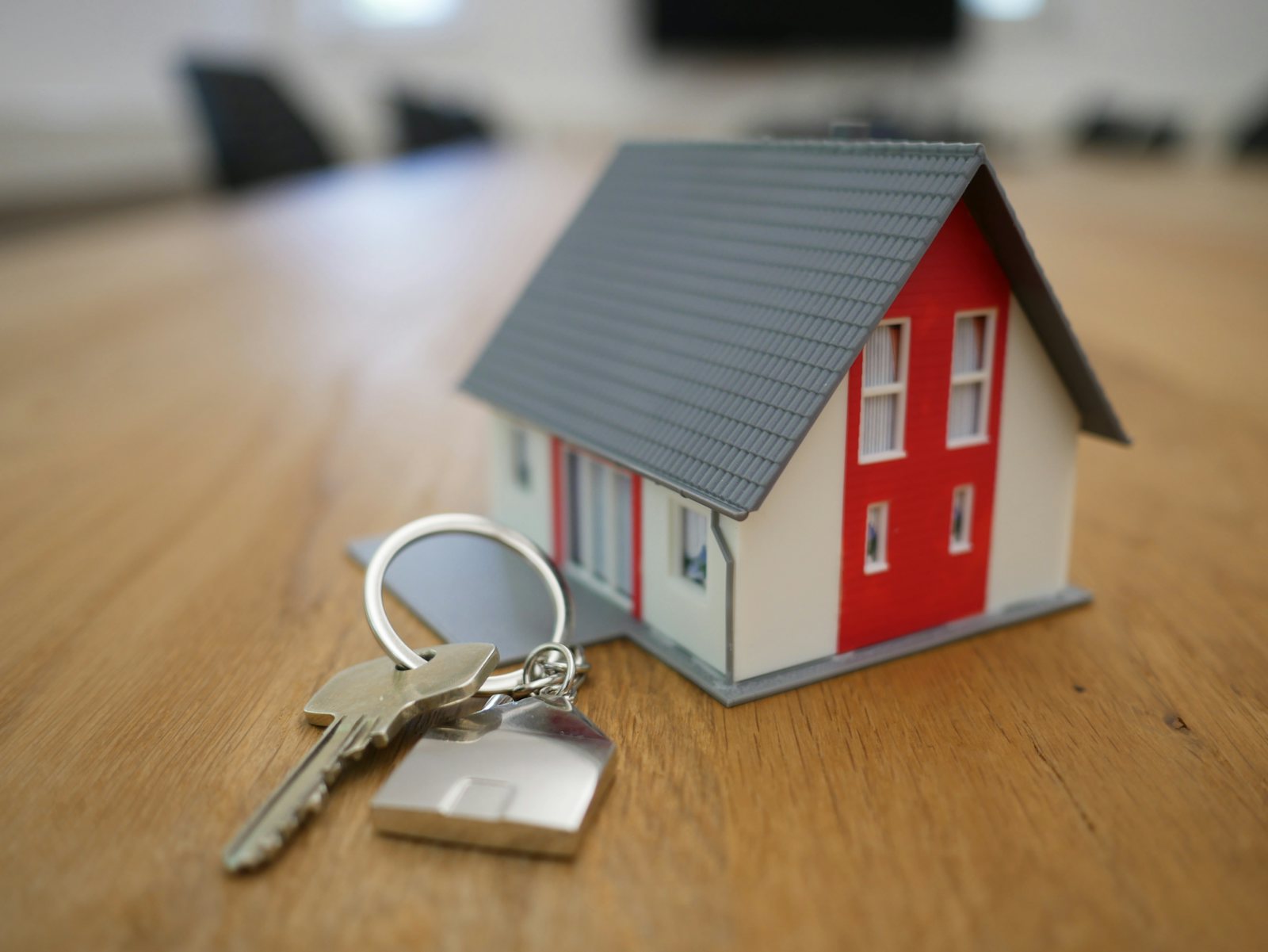 Miniature house model on a table with keys