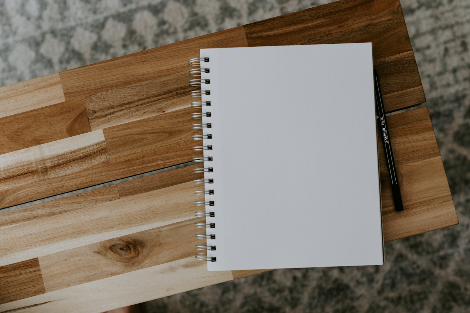 Notebook and pen on a wooden desk