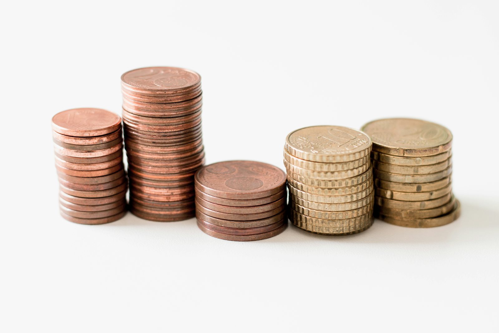 Stacked coins on a white surface