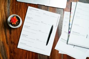Pension paperwork on a desk with a pen